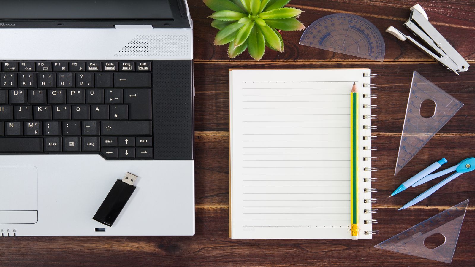 Engineering notebook opened beside server logs.